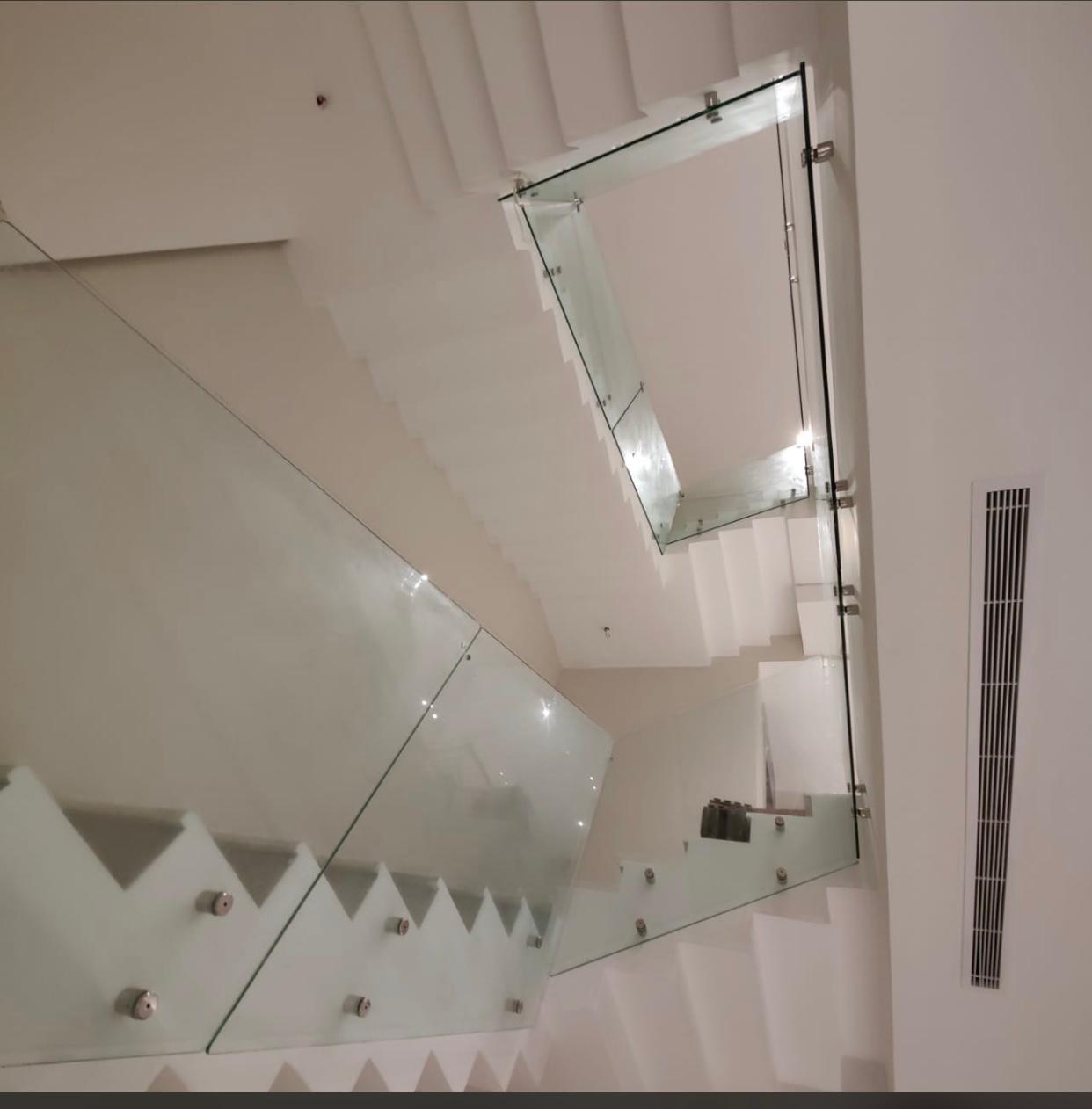 Modern glass staircase railing with LED steps